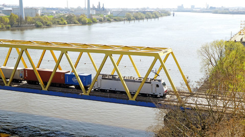A freight train drives over a bridge in the port of Hamburg